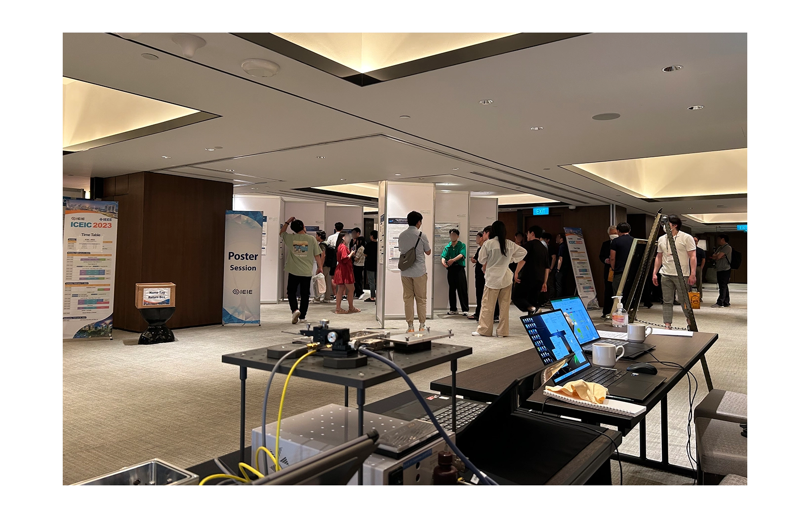 People looking at presentation poster at 2023 ICEIC