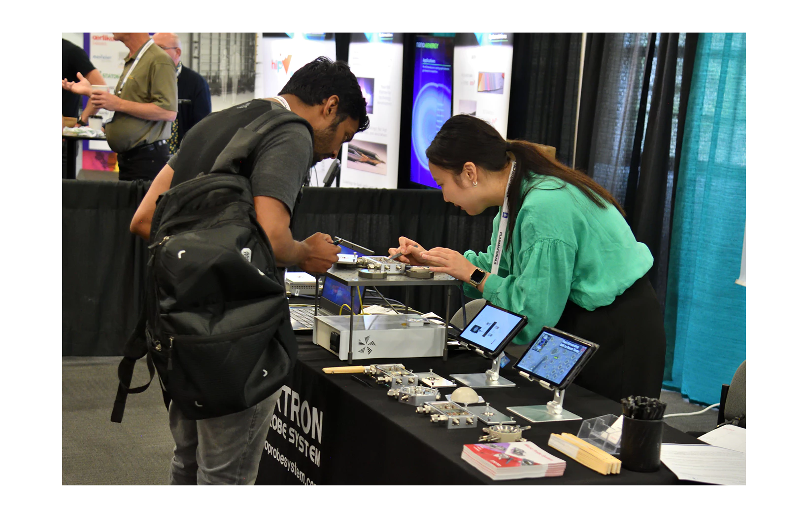 Employees demonstrating and explaining MPS to customers interested in it at the 2023 ICMCTF