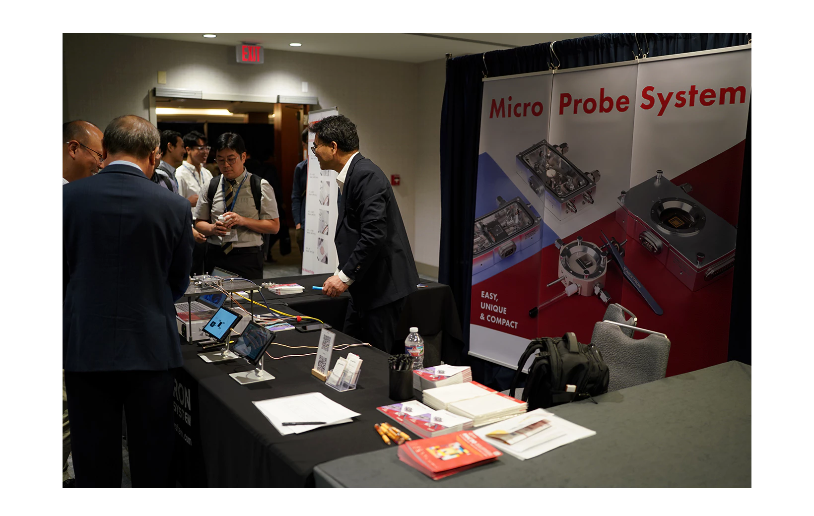 People showing interest in the Nextron booth at 2023 KSEA and the Nextron’s welcoming them
